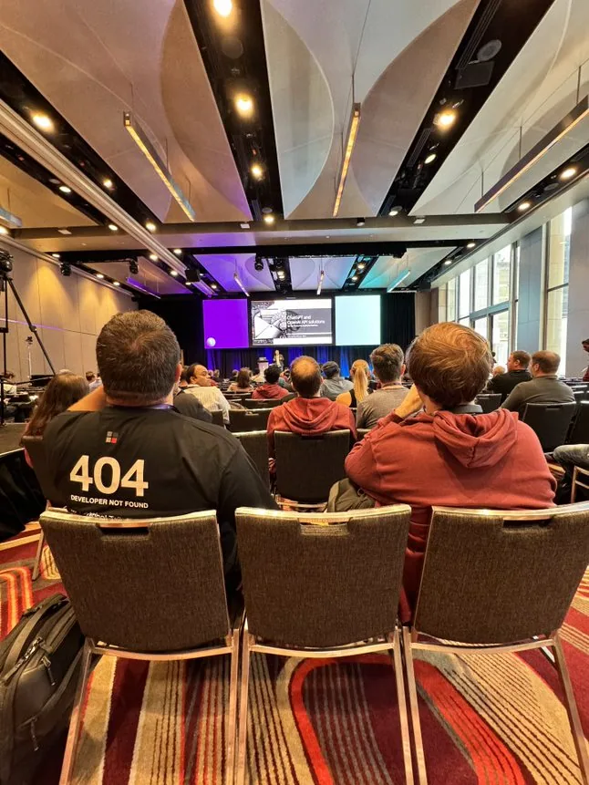 Adam Cogan presenting in a large room
